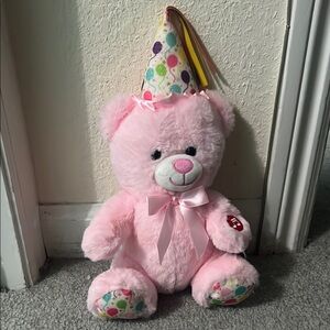 Medium Pink Stuffed Animal with Fluffy Texture and Colorful Party Hat